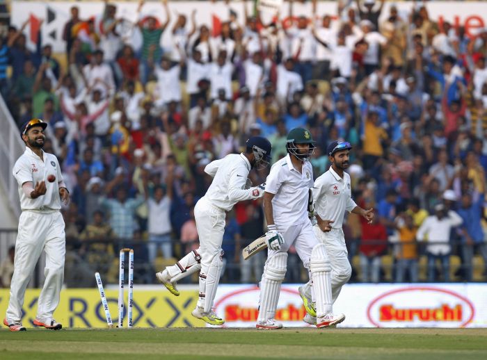 India's captain Virat Kohli, wicketkeeper Wriddhiman Saha and Ajinkya Rahane celebrate the dismissal of South Africa's Imran Tahir during the first day of their third test cricket match in Nagpur India