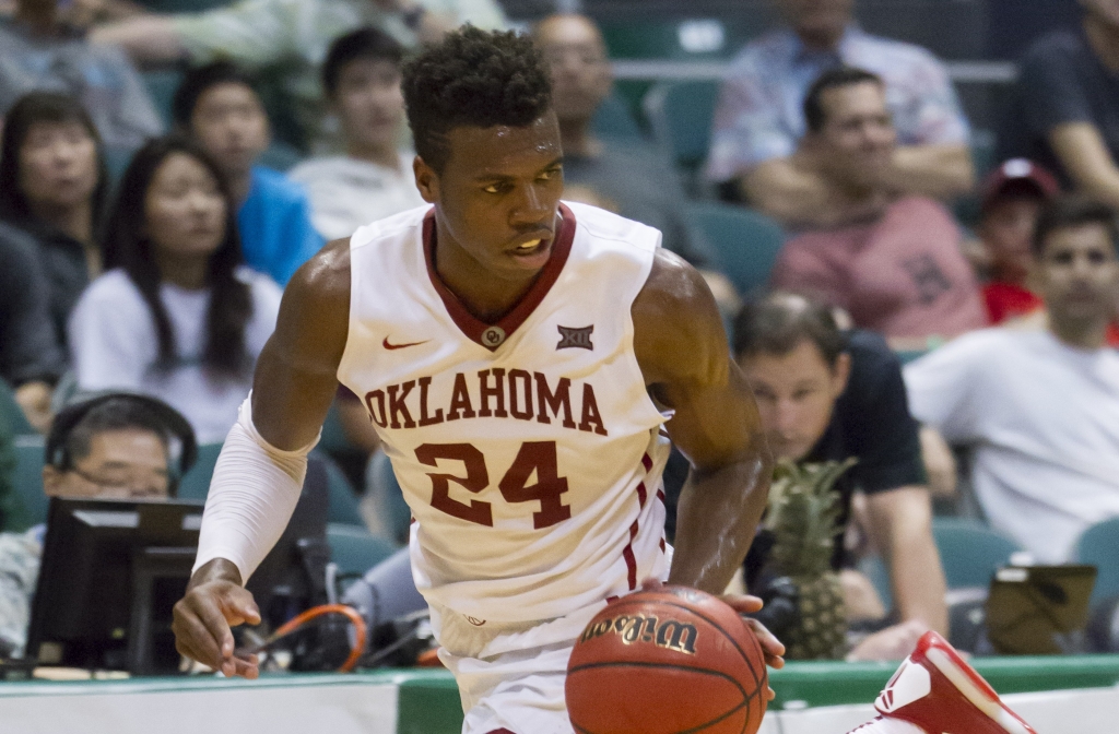 Oklahoma guard Buddy Hield dribbles the basketball up court in the first half of an NCAA college basketball game against Harvard at the Diamond Head Classic Friday Dec. 25 2015 in Honolulu