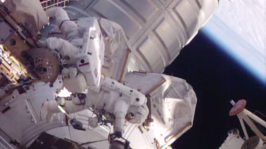 Two astronauts working outside of the International Space Station