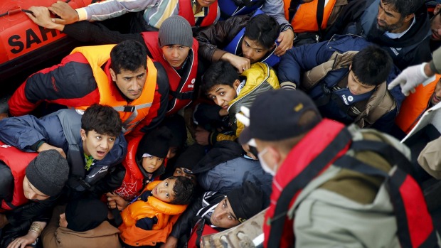 Refugees and migrants wait to board Turkish Coast Guard Search and Rescue ship Umut-703 off the shores of Canakkale Turkey after a failed attempt of crossing to the Greek island of Lesbos