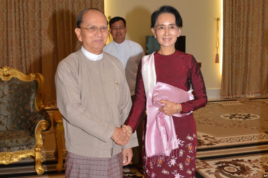 In this image provided by the Myanmar Ministry of Information Myanmar President Thein Sein left shakes hands with opposition leader Aung San Suu Kyi during their meeting at the presidential in Naypyitaw Myanmar Dec. 2 2015