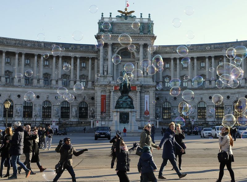 Children try to catch soap bubbles in front of Hofburg palace in Vienna. The Austrian police have beefed up security on concerns of possible shooting or bomb attack before New Year. – Reuters pic