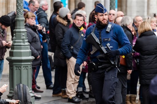 An armed police man patrols at the Grand Place in Brussels on Tuesday Dec. 29 2015. Two people have been arrested in Belgium on suspicion of planning attacks in Brussels during the holidays the federal prosecutor's office said Tuesday. A source close