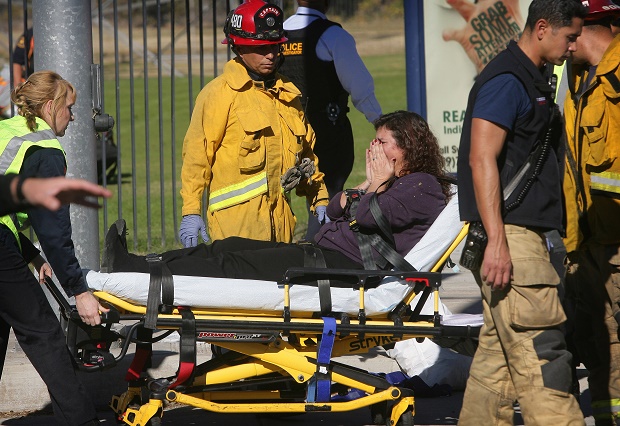 A victim is wheeled away on a stretcher following a shooting that killed multiple people at a social services facility Wednesday Dec. 2 2015 in San Bernardino Calif.  MAGS OUT MANDATORY CREDIT LOS ANGELES