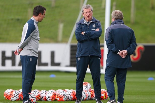 BURTON-UPON-TRENT ENGLAND- SEPTEMBER 02 England manager Roy Hodgson speaks with coach Gary Neville