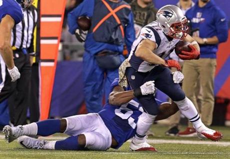 East Rutherford NJ- 11/15/15- New England Patriots wide receiver Julian Edelman suffered a broken bone in his foot on this play where he was tackled by New York Giants middle linebacker Jasper Brinkley at the end of the first quarter. The