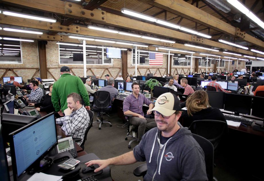 Workers sit at their computers at Redwood headquarters in Chicago Dec. 3 2015. The U.S. added 211,000 jobs in November and the unemployment rate remained flat clearing the way for policymakers to raise benchmark interest rates when they meet in Decembe