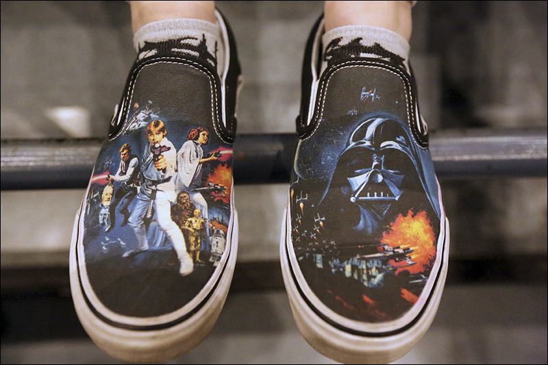 Part-time Franklin Park theater employee Tess Westcott 19 sported themed shoes along with a ‘Star Wars’ T-shirt while she waited several hours inside the theater to see the new film