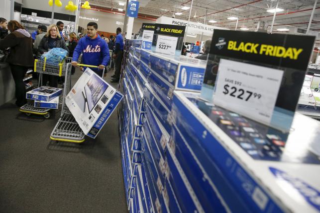 Shoppers leave with check out with their purchases from the Best Buy store in Westbury New York