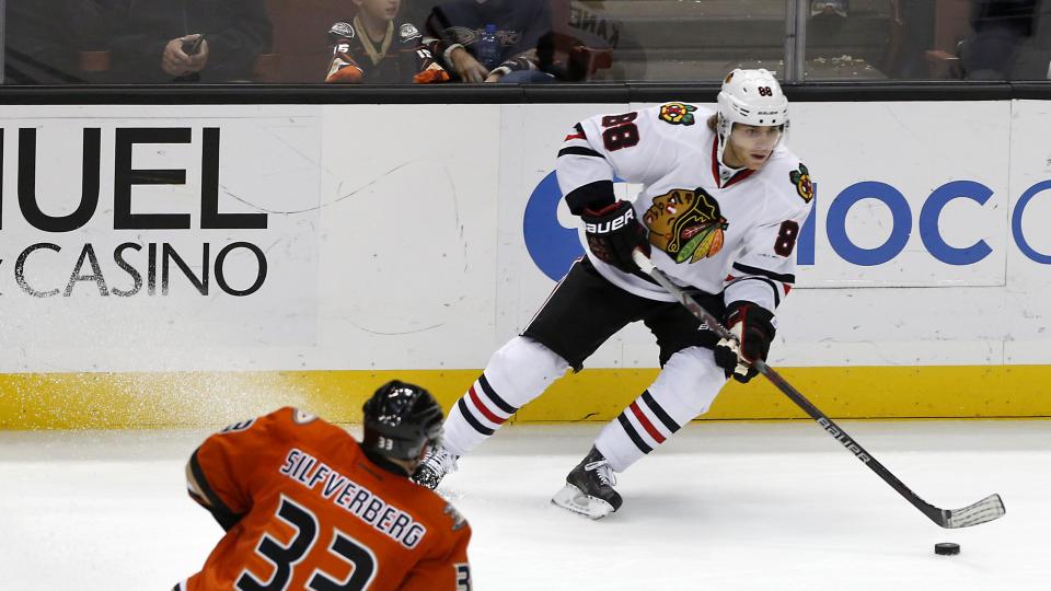 Chicago Blackhawks right wing Patrick Kane looks to pass as Anaheim Ducks Jakob Silfverberg defends during the third period of an NHL hockey game in Anaheim Calif. Friday Nov. 27 2015. Chicago won in overtime 3-2. (AP