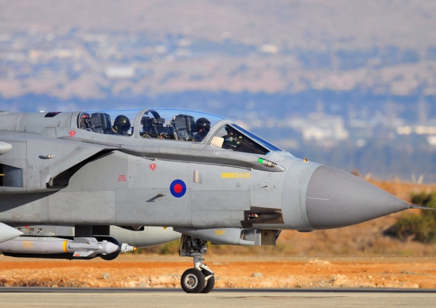 The pilot and navigator sit in the cockpit of an RAF Tornado GR4 as they land at RAF Akrotiri in Cyprus after returning to the base from carrying out some of the first British bombing runs over Syria