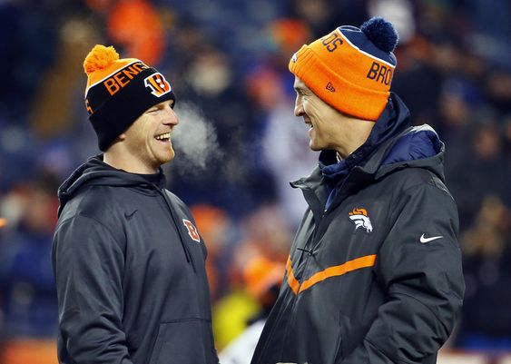 Andy Dalton and Denver Broncos quarterback Peyton Manning talk prior to an NFL football game Monday Dec. 28 2015 in Denver