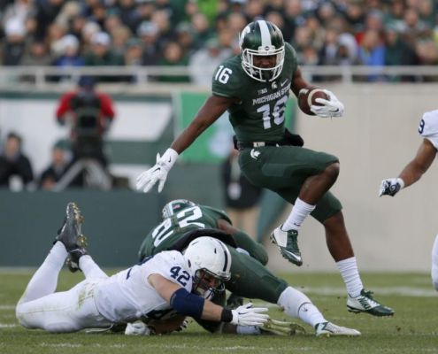 Michigan State's Aaron Burbridge hurdles Penn State's