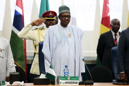 Nigeria's President Muhammadu Buhari stands at the opening of the 48th ordinary session of ECOWAS Authority of Head of States and Government in Abuja Nigeria