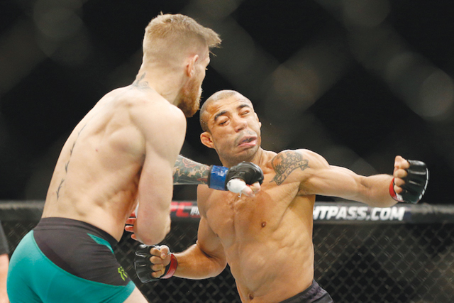 Conor McGregor left fights Jose Aldo during a featherweight championship mixed martial arts bout at UFC 194 Saturday Dec. 12 2015 in Las Vegas. Mc Gregor stopped Aldo with one spectacular punch just 13 seconds into the first round Saturday night bac