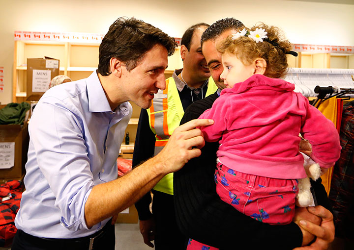 Syrian refugees are greeted by Canada's Prime Minister Justin Trudeau on their arrival from Beirut at the Toronto Pearson International Airport in Mississauga Ontario Canada