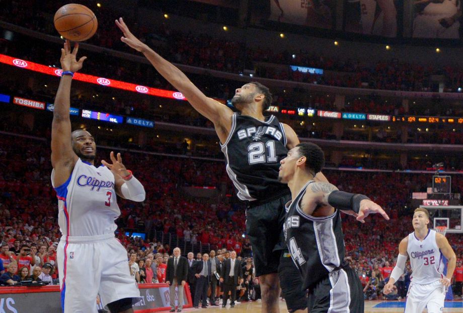 Los Angeles Clippers guard Chris Paul shoots with a second left as Spurs forward Tim Duncan defends in Game 7 of a first-round playoff series in 2015