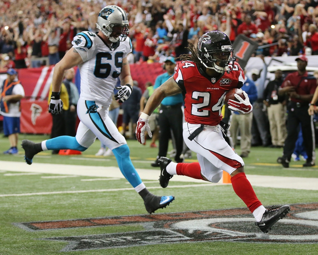 122815 ATLANTA Falcons running back Devonta Freeman gets past Panthers Jared Allen for a touchdown to tie the game 7-7 during the second quarter in a football game on Sunday Dec. 27 2015 in Atlanta. Curtis Compton