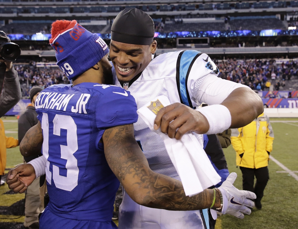 Carolina Panthers&#039 Cam Newton right hugs New York Giants&#039 Odell Beckham after an NFL football game Sunday Dec. 20 2015 in East Rutherford N.J. The Panthers won 38-35