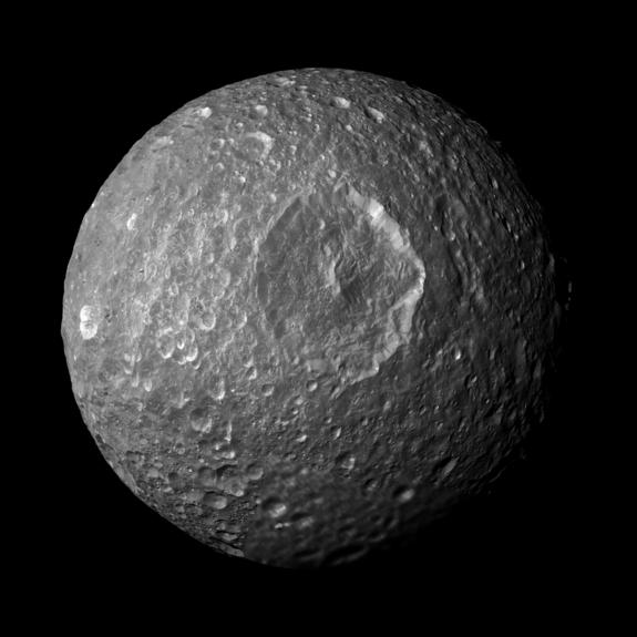 This mosaic created from images taken by NASA's Cassini spacecraft during its closest flyby of Saturn's moon Mimas on Feb. 13 2010 looks straight at the moon's Herschel crater and reveals new insights about the moon's surface. Hersc