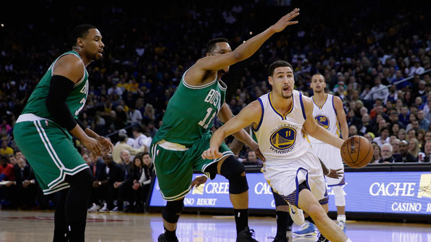 Celtics guard Evan Turner plays defense against Golden State guard Klay Thompson