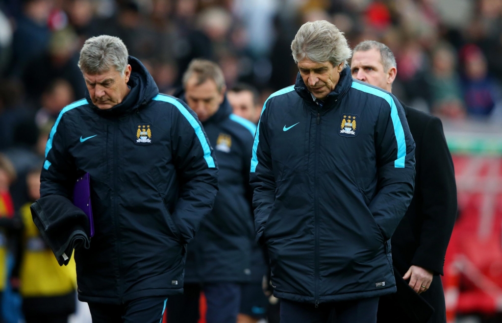 STOKE ON TRENT ENGLAND- DECEMBER 05 Manuel Pellegrini, manager of Manchester City and caoch Brian Kidd leave the pitch at the half time during the Barclays Premier League match between Stoke City and Manchester City at Britannia Stadium on Dec