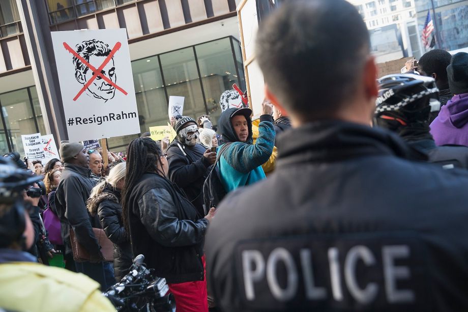 Demonstrators in downtown Chicago call for the resignation of Mayor Rahm Emanuel