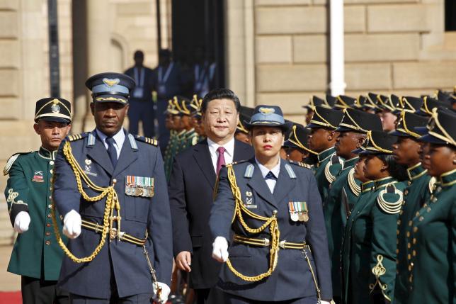 Chinese President Xi Jinping walks past a the guard of honour on arrival at the Union Buildings in Pretoria for his meeting with South African President Jacob Zuma