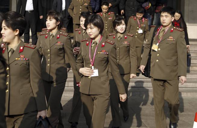 Chinatopix via AP Members of the Moranbong band wait Friday to leave the hotel for a rehearsal in Beijing