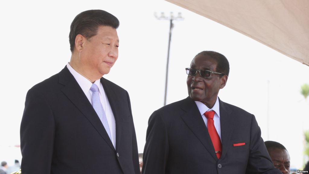 Chinese President Xi Jinping talks with Zimbabwean President Robert Mugabe on arrival for a state visit in Harare Zimbabwe Dec. 1 2015