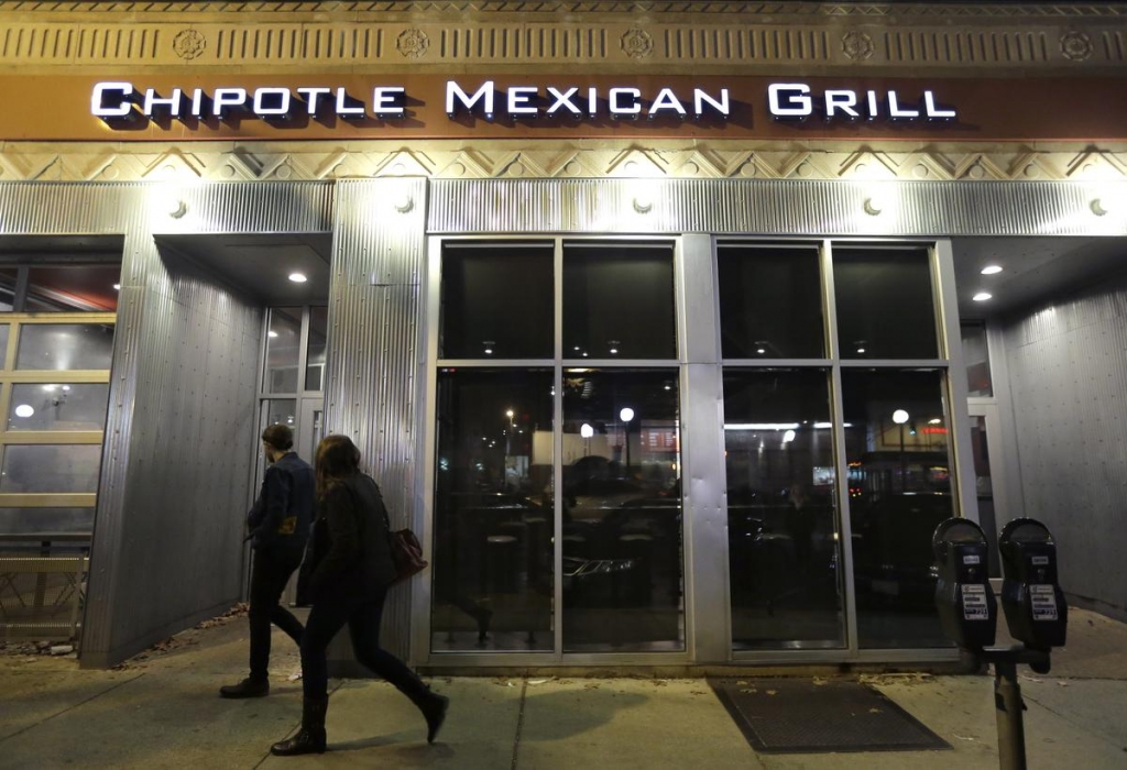 A pedestrian walks past a closed Chipotle restaurant Monday Nov. 2 2015 in Seattle. An E. coli outbreak linked to Chipotle restaurants in Washington state and Oregon has sickened nearly two dozen people in the third outbreak of foodborne illness at the