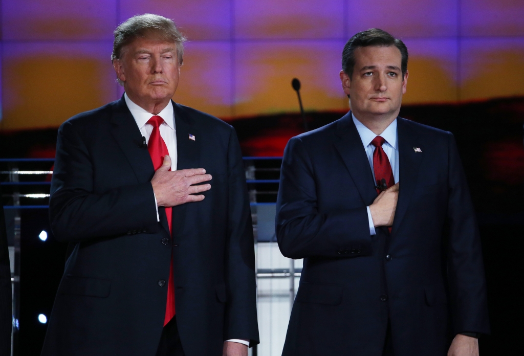 LAS VEGAS NV DECEMBER 15 Republican presidential candidates Donald Trump and U.S. Sen. Ted Cruz hold their hands over their hearts during the National Anthem during the CNN Republican presidential debate