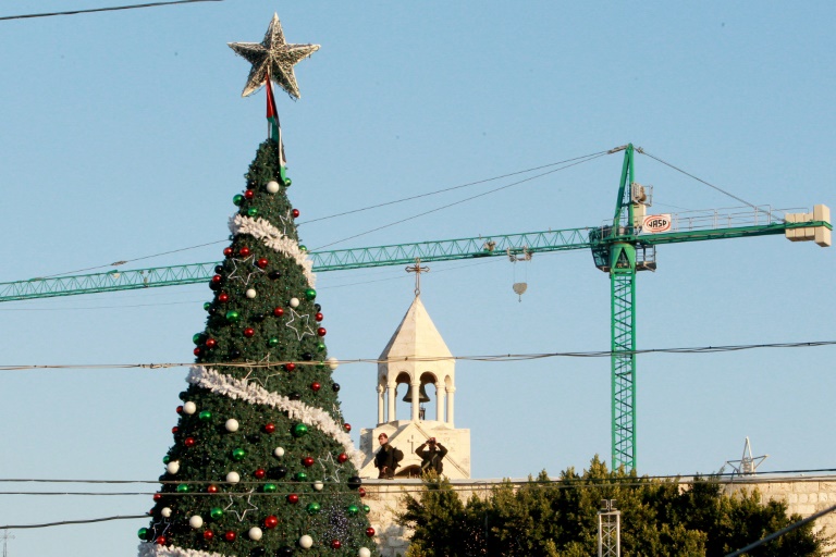 AFP  Musa Al-ShaerPalestinian security forces stand guard on the roof of the Church of the Nativity as Christians gather for Christmas celebrations in the West Bank city of Bethlehem