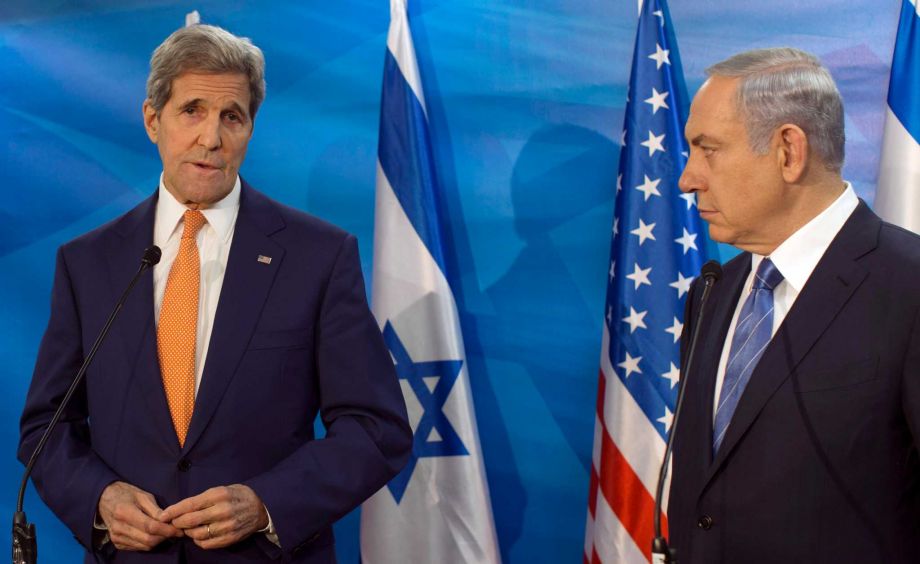 Israel's Prime Minister Benjamin Netanyahu right looks on as U.S. Secretary of State John Kerry speaks during a meeting at the Prime Minister's Office in Jerusalem. On Saturday Kerry warned Israel abou