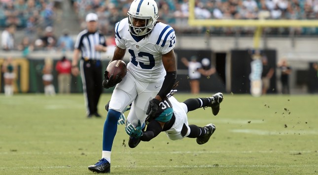 JACKSONVILLE FL- DECEMBER 13 T.Y. Hilton #13 of the Indianapolis Colts is brought down by Davon House #31 of the Jacksonville Jaguars during the second quarter of a game at Ever Bank Field