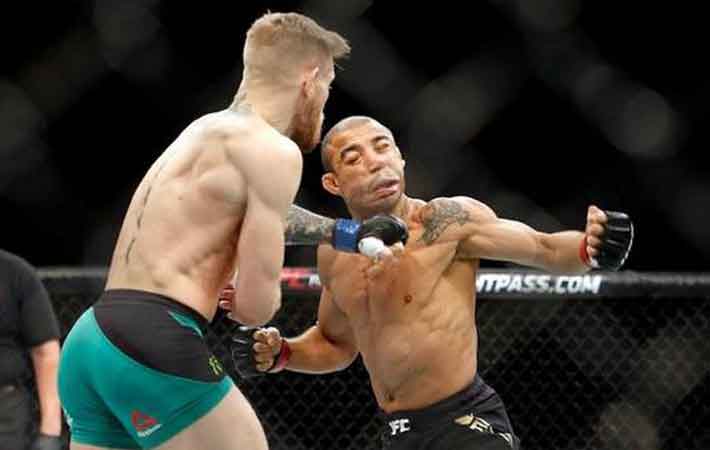 Conor Mc Gregor lands punch knocking out Jose Aldo