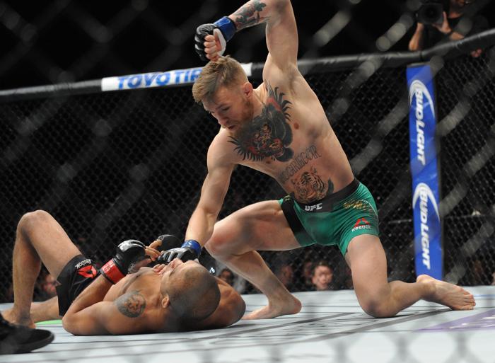 Las Vegas NV USA Conor Mc Gregor lands punches to win b technical knockout against Jose Aldo during UFC 194 at MGM Grand Garden Arena. Mandatory Credit Gary A. Vasquez-USA TODAY Sports