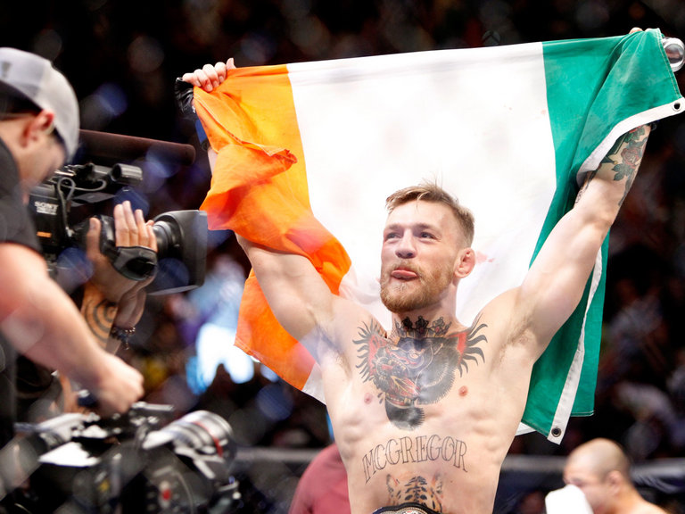 Conor Mc Gregor celebrates his victory over Jose Aldo