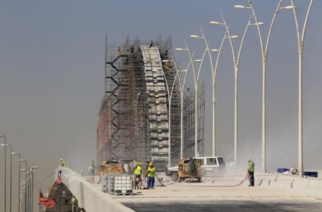 Construction labourers work at the site of the development project of King Abdullah Road in Riyadh