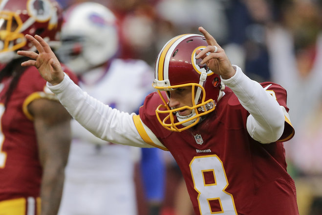 Washington Redskins quarterback Kirk Cousins celebrates wide receiver Pierre Garcon's touchdown during the second half of an NFL football game against the Buffalo Bills in Landover Md. Sunday Dec. 20 2015