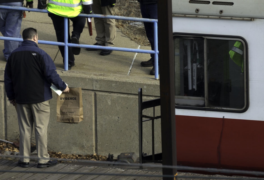 Credit Mark Garfinkel        INVESTIGATION MBTA officials above are seen near a Red Line train that ran for 9 minutes without a driver yesterday