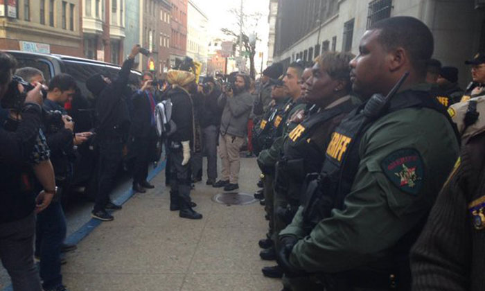 Sheriff's deputies form a human chain in front of the courthouse