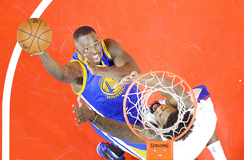 Golden State Warriors forward Draymond Green left shoots as Los Angeles Clippers center De Andre Jordan defends during the second half of an NBA basketball game Thursday Nov. 19 2015 in Los Angeles. The Warriors won 124-117. (AP