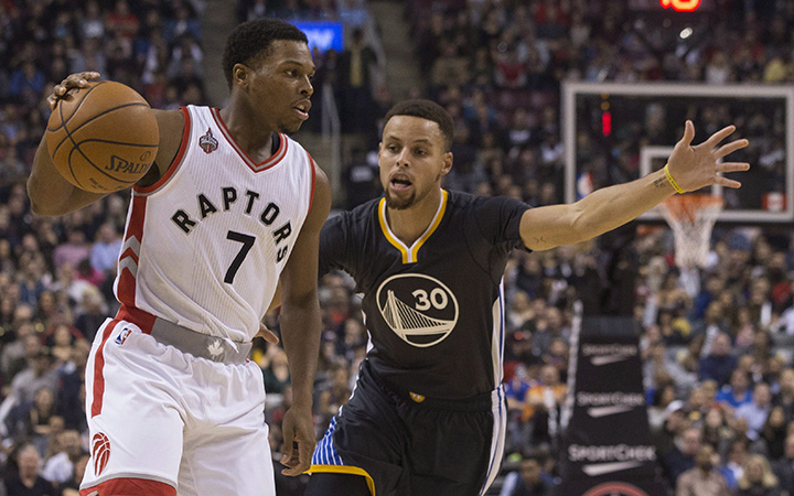 Toronto Raptors&#039 Kyle Lowry looks to make a pass as Golden State Warriors&#039 Stephen Curry defends during first half NBA basketball action in Toronto on Saturday