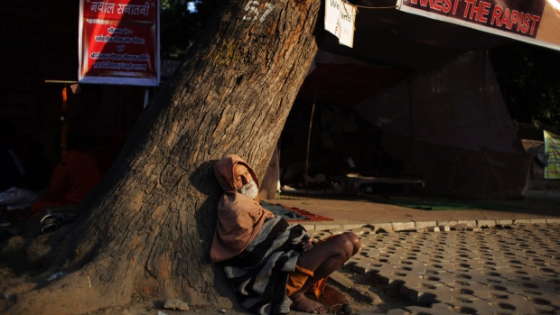 Man near banner against rape in India