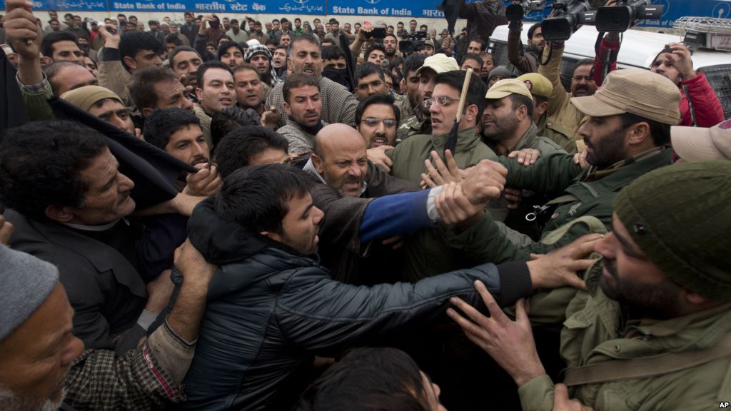 Activists of the Awami Ittihad party get into a scuffle with Indian policemen as they are stopped during a protest to mark International Human Rights Day in Srinagar India Dec. 10 2015