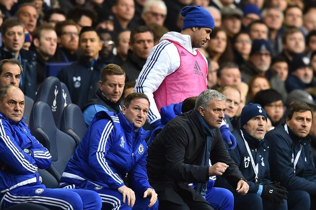 Diego Costa passes Jose Mourinho as he goes to warm