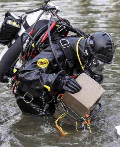 An FBI dive team conducts a search for any evidence that may have been left by the husband and wife behind the San Bernardino massacre at Seccombe Lake Park in San Bernardino California