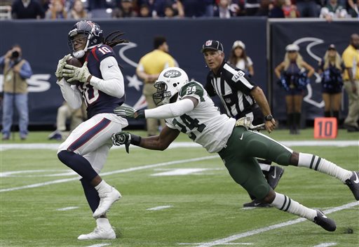 Houston Texans wide receiver De Andre Hopkins pulls in a pass for a touchdown as he is defended by New York Jets cornerback Darrelle Revis during the first half of an NFL football game Sunday Nov. 22 2015 in Houston