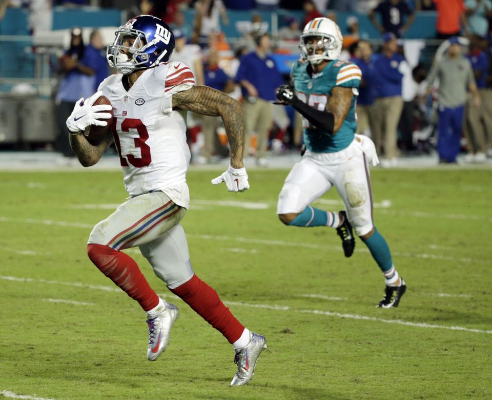 Giants forge 1st-place tie by beating Dolphins 31-24